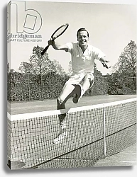 Постер Man holding tennis racquet leaping over tennis net, 1950-60s, black and white