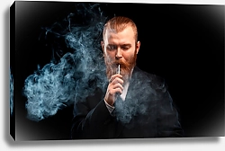 Постер Мужчина с рыжей бородой курит электронную сигарету