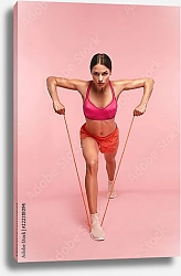 Постер Спортсменка с эспандером на розовом фоне
