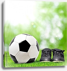 Постер Футбольный мяч и бутсы на зеленой траве