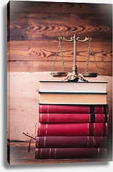 Постер Золотые весы на вершине стопки юридических книг