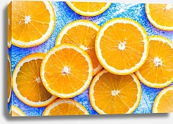 Постер Нарезанный апельсин на синем деревянном столе
