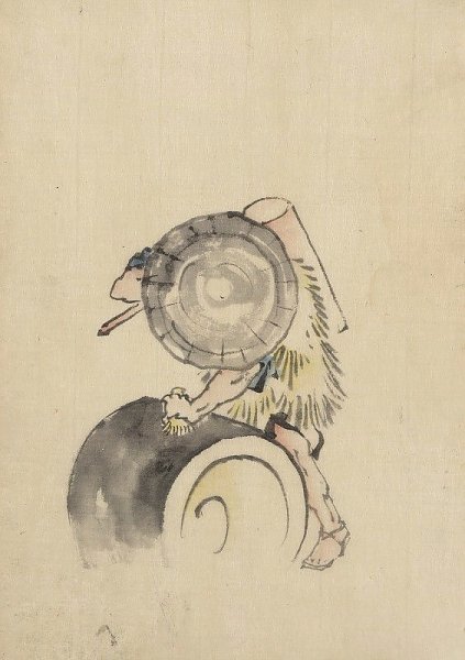 A man, wearing a large conical hat and a straw or feather garment