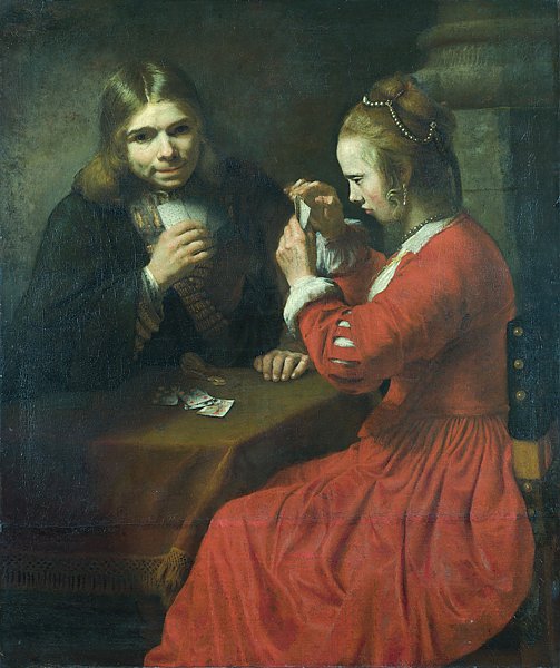 Молодые юноша и девушка, играющие в карты
