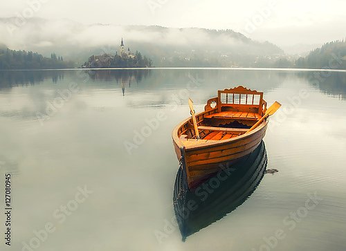 Одинокая лодка на водной поверхности озера Блед, Словения