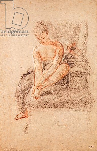 Semi-nude woman seated on a chaise longue, holding her foot