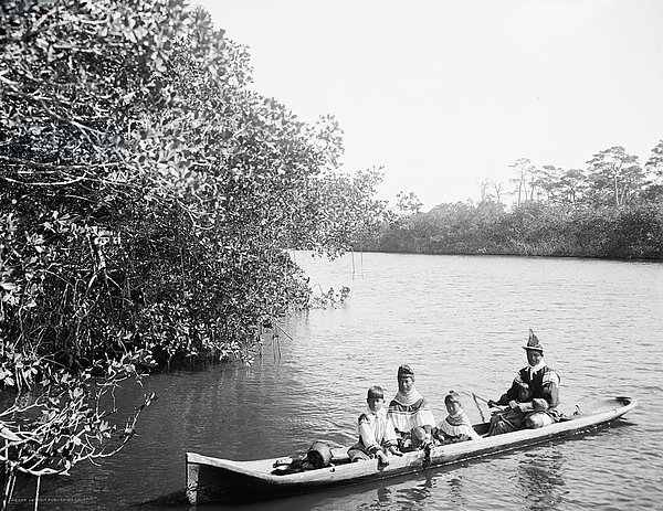 Seminole Indian and family dugout canoe, Miami, Florida, c.1910-20
