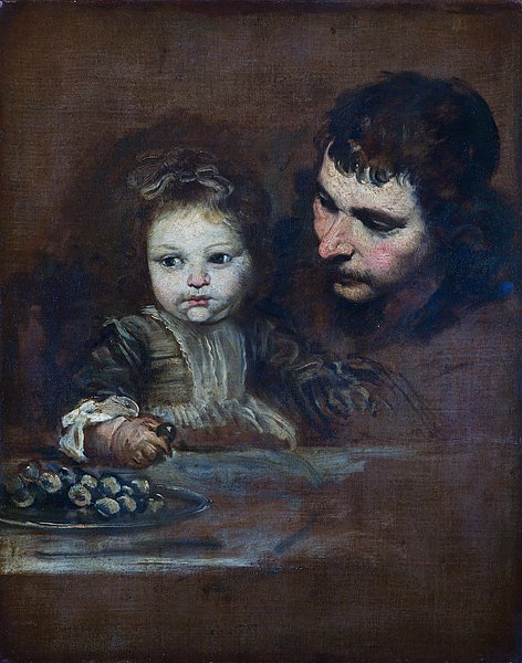 Мужчина с младенцем едят виноград