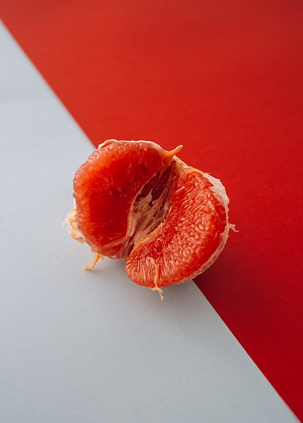 Очищенный грейпфрут на красно-белом