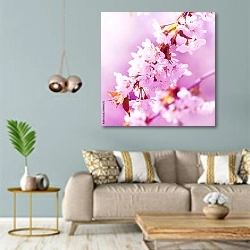 «Цветущие весенние ветви в розовом свете» в интерьере современной гостиной с голубыми стенами