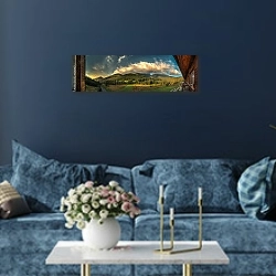 «Вид на горы из комнаты гостиницы» в интерьере стильной синей гостиной над диваном