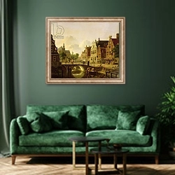 «Dutch town scene with canal, figures and a church» в интерьере зеленой гостиной над диваном