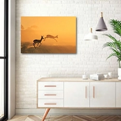 «Скачущие антилопы на закате в прерии» в интерьере комнаты в скандинавском стиле над тумбой