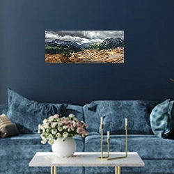 «Горнодобывающий карьер в горах» в интерьере стильной синей гостиной над диваном