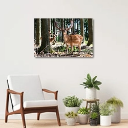 «Три молодых оленя в лесу» в интерьере современной комнаты над креслом