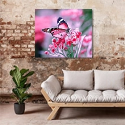 «Постер с бабочкой в розовых тонах» в интерьере гостиной в стиле лофт над диваном