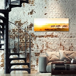 «Панорама с зебрами, бредущими на фоне заката» в интерьере двухярусной гостиной в стиле лофт с кирпичной стеной