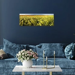 «Поле пшеницы и маков» в интерьере стильной синей гостиной над диваном