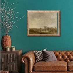 «Ландшафт со стогами кукурузы» в интерьере гостиной с зеленой стеной над диваном