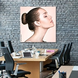 «Портрет женщины со стрелками на лице» в интерьере современного офиса с черной кирпичной стеной