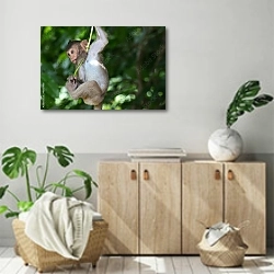 «Мартышка качается на лиане в лесу» в интерьере современной комнаты над комодом