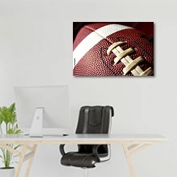«Мяч для игры в американский футбол крупным планом» в интерьере офиса над рабочим местом