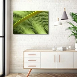 «зеленые волны пальмового листа» в интерьере комнаты в скандинавском стиле над тумбой