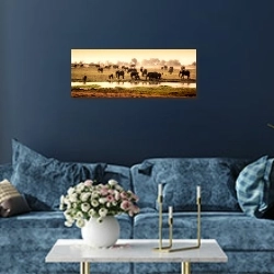 «Африканские слоны у воды» в интерьере стильной синей гостиной над диваном
