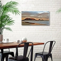 «Морское побережье на фоне горы» в интерьере столовой в скандинавском стиле с кирпичной стеной