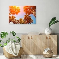 «Пальмы на фоне неба на закате» в интерьере современной комнаты над комодом