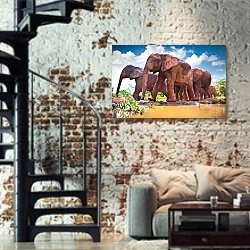 «Стадо слонов, идущих по реке в Кении» в интерьере двухярусной гостиной в стиле лофт с кирпичной стеной