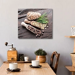 «Две ложки с кедровыми орешками и шишка на деревянном столе» в интерьере кухни над обеденным столом с кофемолкой