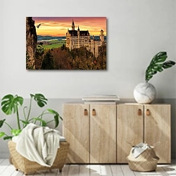 «Замок Нойшванштайн на закате» в интерьере современной комнаты над комодом