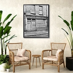 «The facade of 29 Hanbury Street, 1888» в интерьере комнаты в стиле ретро с плетеными креслами