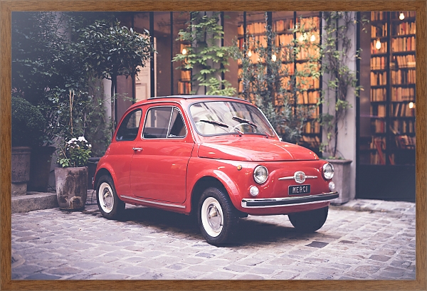 Постер Маленький красный ретро-автомобиль на улице с типом исполнения На холсте в раме в багетной раме 1727.4310