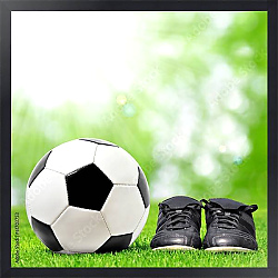 Постер Футбольный мяч и бутсы на зеленой траве