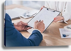 Постер cropped view of businesswoman holding clipboard and client signing agreement