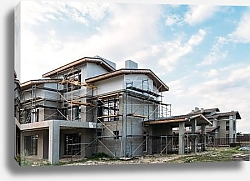 Постер modern building construction with scaffolding under cloudy sky