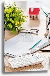 Постер selective focus of calculator near coins, paper, glasses, green plant and house model on wooden table