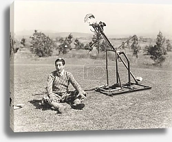 Постер Robot hitting golf ball on man's head