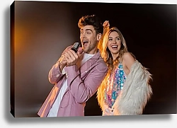 Постер man singing while holding microphone near happy blonde woman on black