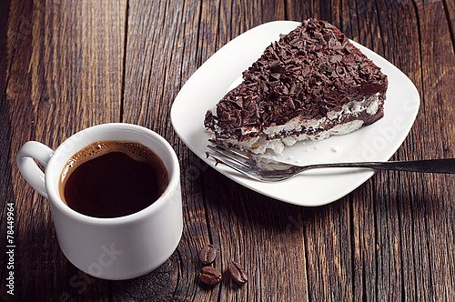 Кусок шоколадного торта и кофе на деревянном столе