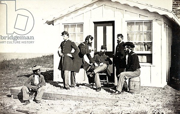 Five Civil War soldiers gathered on dirt porch outside home