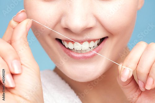 Чистка зубов с помощью зубной нити