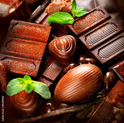 Шоколад и конфеты, присыпанные корицей с листочками мяты