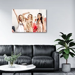 «beautiful smiling multiethnic girls in nightwear singing karaoke at pajama party in bedroom» в интерьере офиса в зоне отдыха над диваном