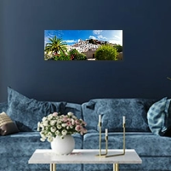«Испания, Ибица. Панорама» в интерьере стильной синей гостиной над диваном
