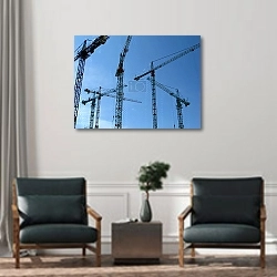 «Два строительных крана» в интерьере офиса над креслами для гостей