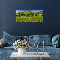 «Деревянные дома на поле одуванчиков» в интерьере стильной синей гостиной над диваном