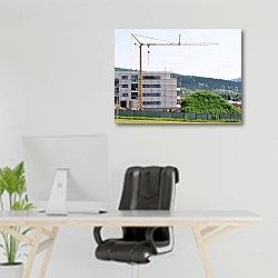 «Кран на фоне строящегося дома» в интерьере офиса над рабочим местом